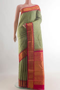 Pure Silk Sage Green Kanchipuram Saree with Zari Butta on the body and Zari Border.  displayed on a mannequin