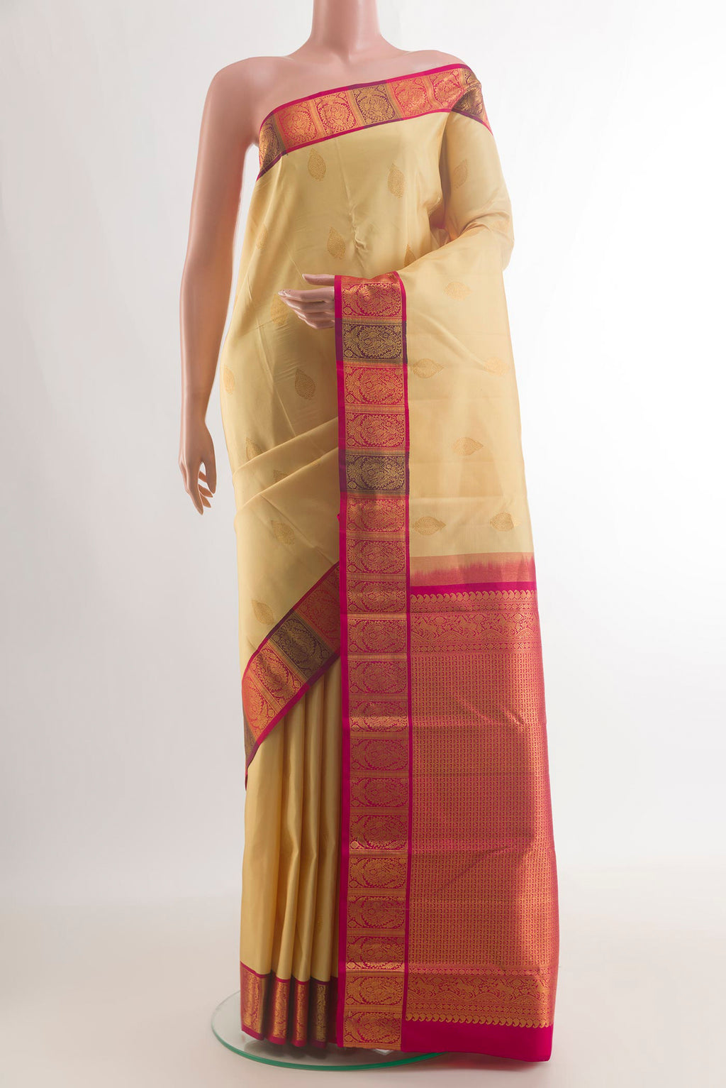 Pure Silk Sandal Kanchipuram Saree with Zari Butta on the body and Zari Border.  displayed on a mannequin