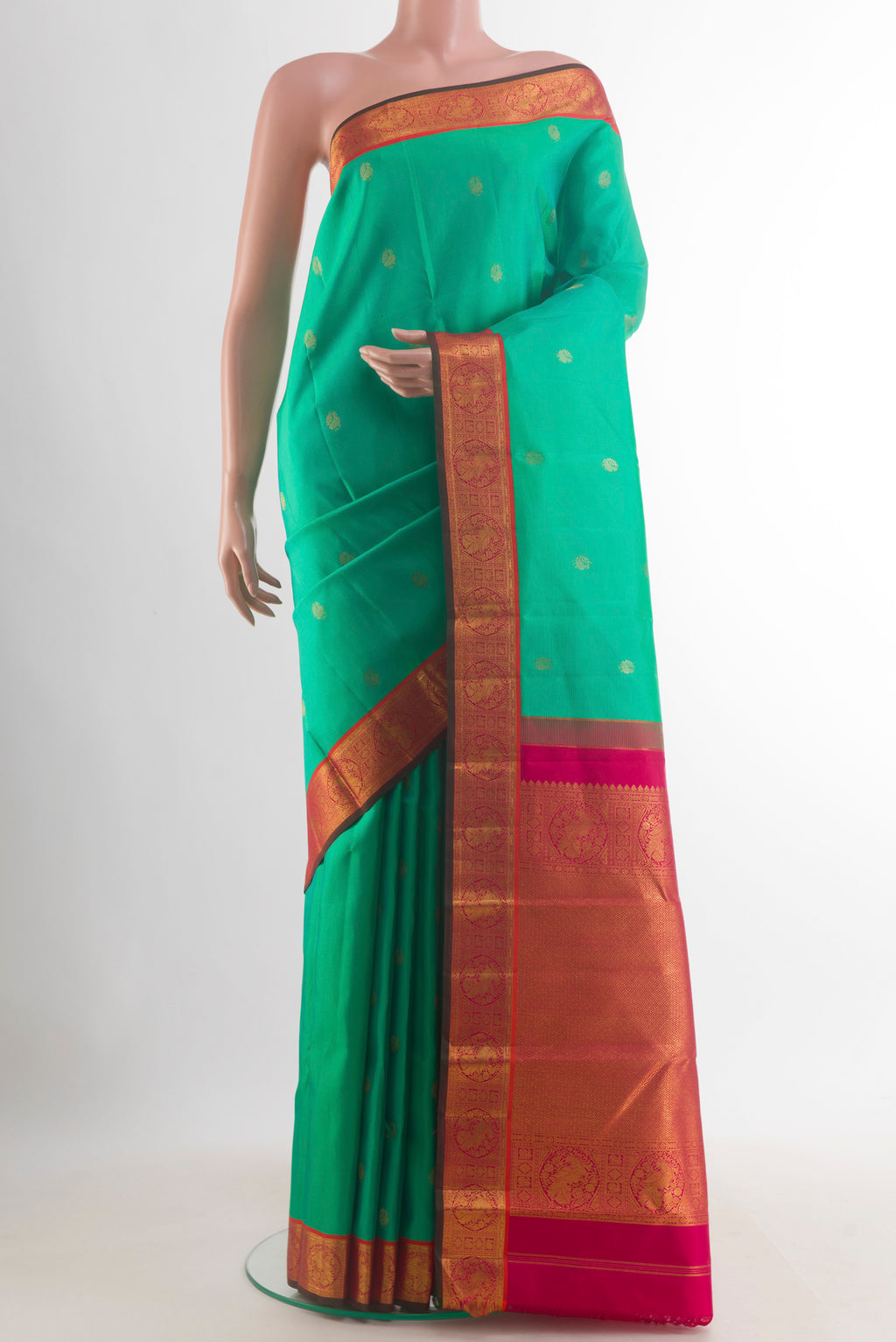 Pure Silk Green Kanchipuram Saree with Zari Butta on the body and Zari Border.  displayed on a mannequin