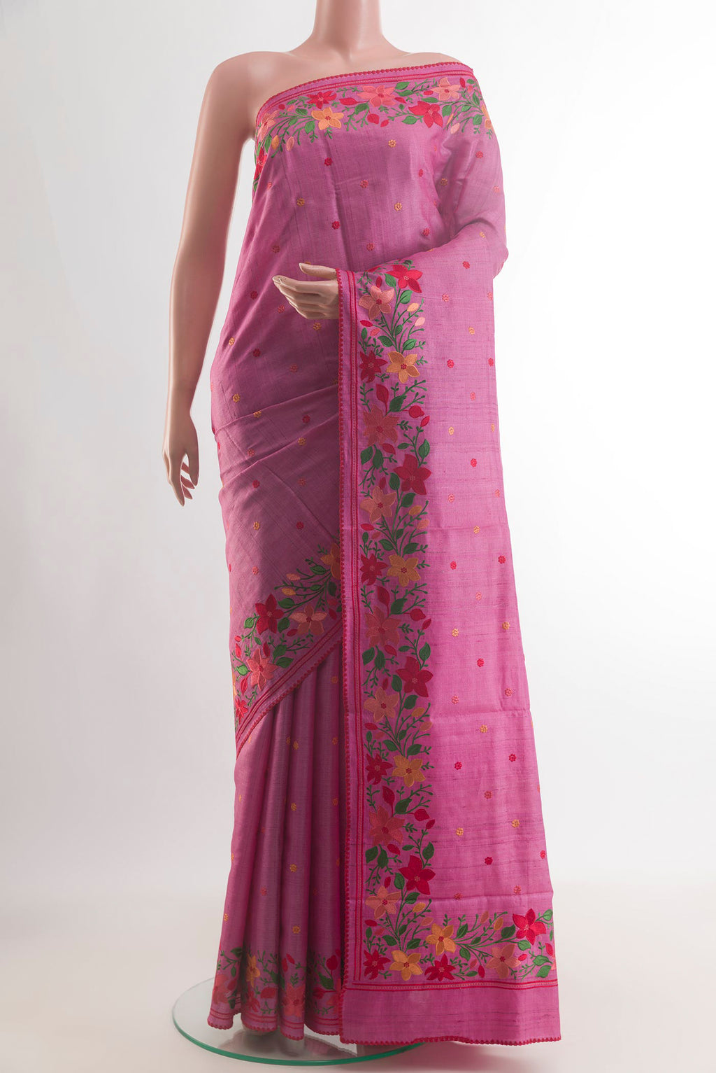 Pink Tussar Saree with Embroidery on the body and Embroidery Border.  displayed on a mannequin