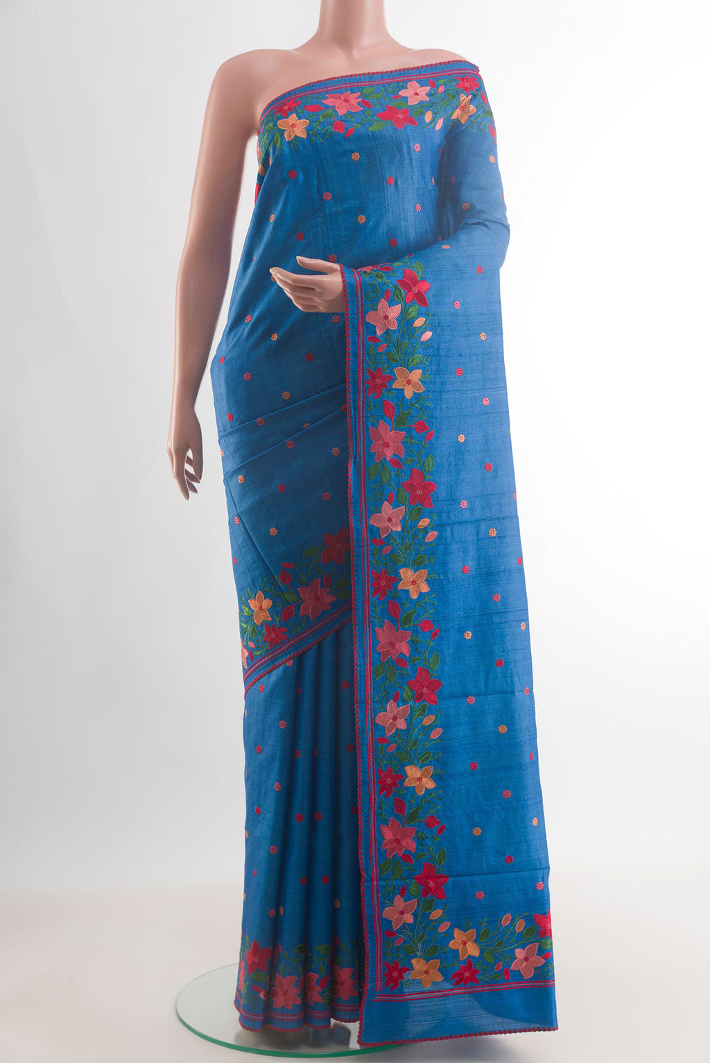 Blue Tussar Saree with Embroidery on the body and Embroidery Border.  displayed on a mannequin