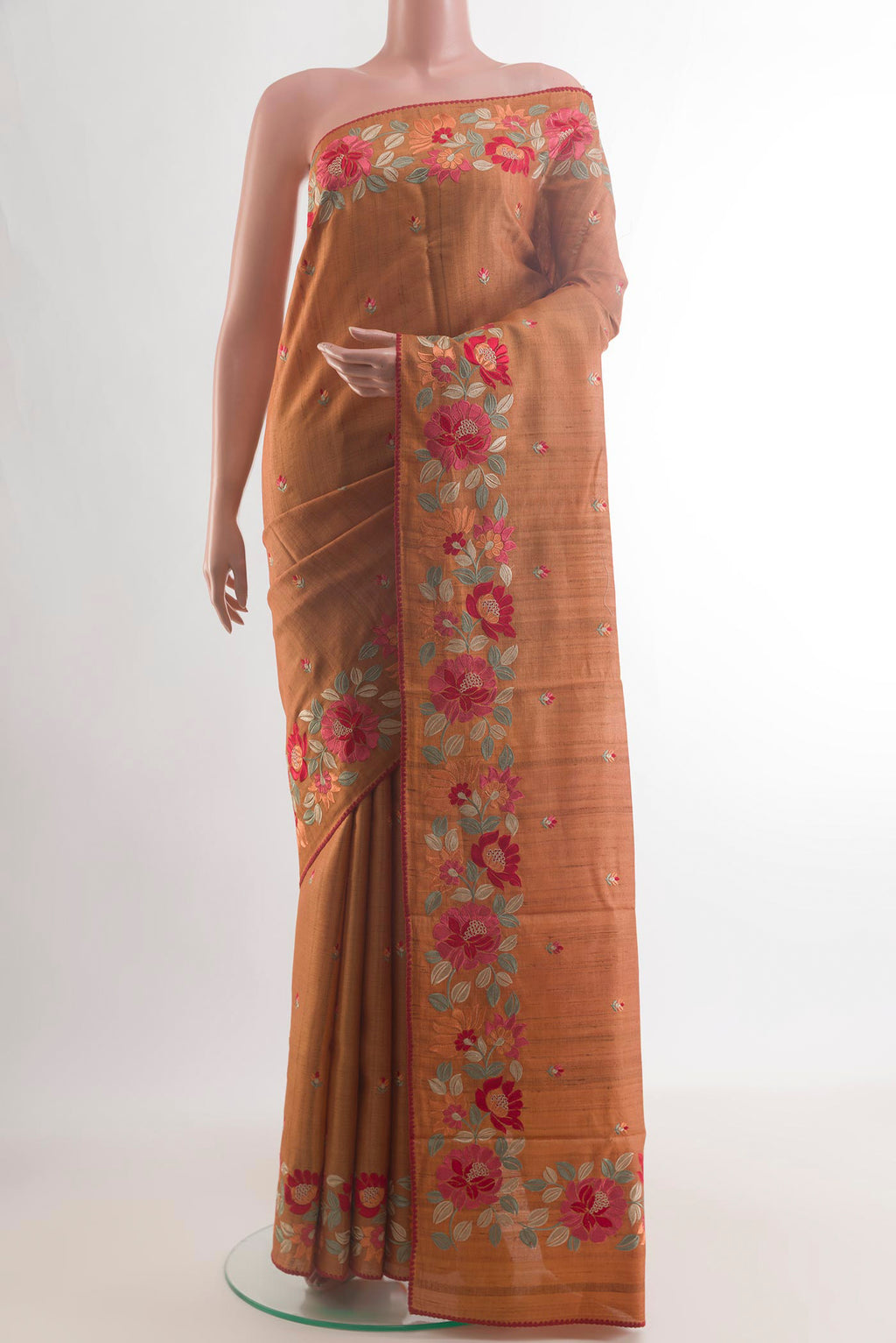 Brick Orange Tussar Saree with Embroidery on the body and Embroidery Border.  displayed on a mannequin