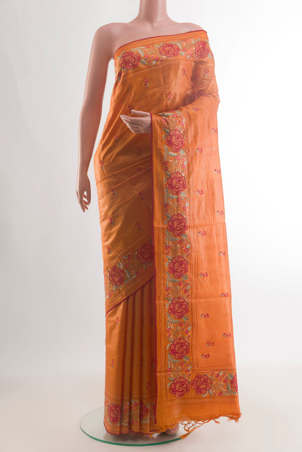 Orange Tussar Saree with Embroidery on the body and Embroidery Border.  displayed on a mannequin