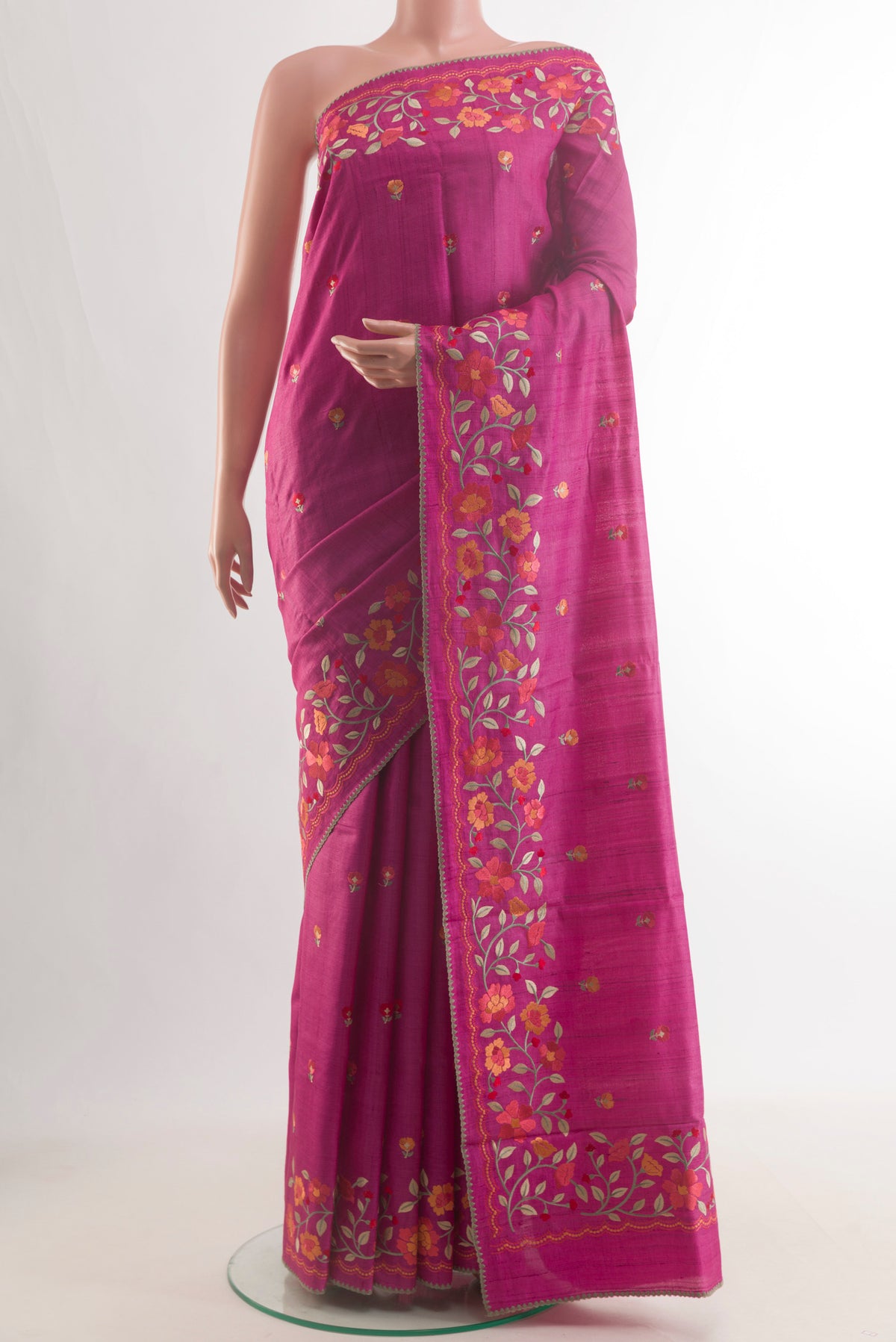 Pink Tussar Saree with Embroidery on the body and Embroidery Border.  displayed on a mannequin