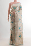 Beige Tussar Saree with Embroidery on the body and Embroidery Border.  displayed on a mannequin