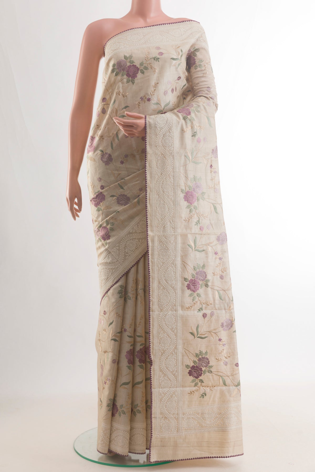 Cream Tussar Saree with Embroidery on the body and Embroidery Border.  displayed on a mannequin