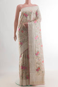 Cream Tussar Saree with Embroidery on the body and Embroidery Border.  displayed on a mannequin