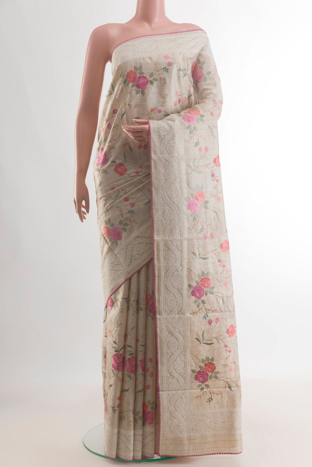 Cream Tussar Saree with Embroidery on the body and Embroidery Border.  displayed on a mannequin
