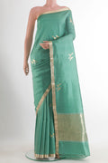 Pure Silk Green Banarasi Katan Saree with Zari Butta on the body and Zari Border.  displayed on a mannequin