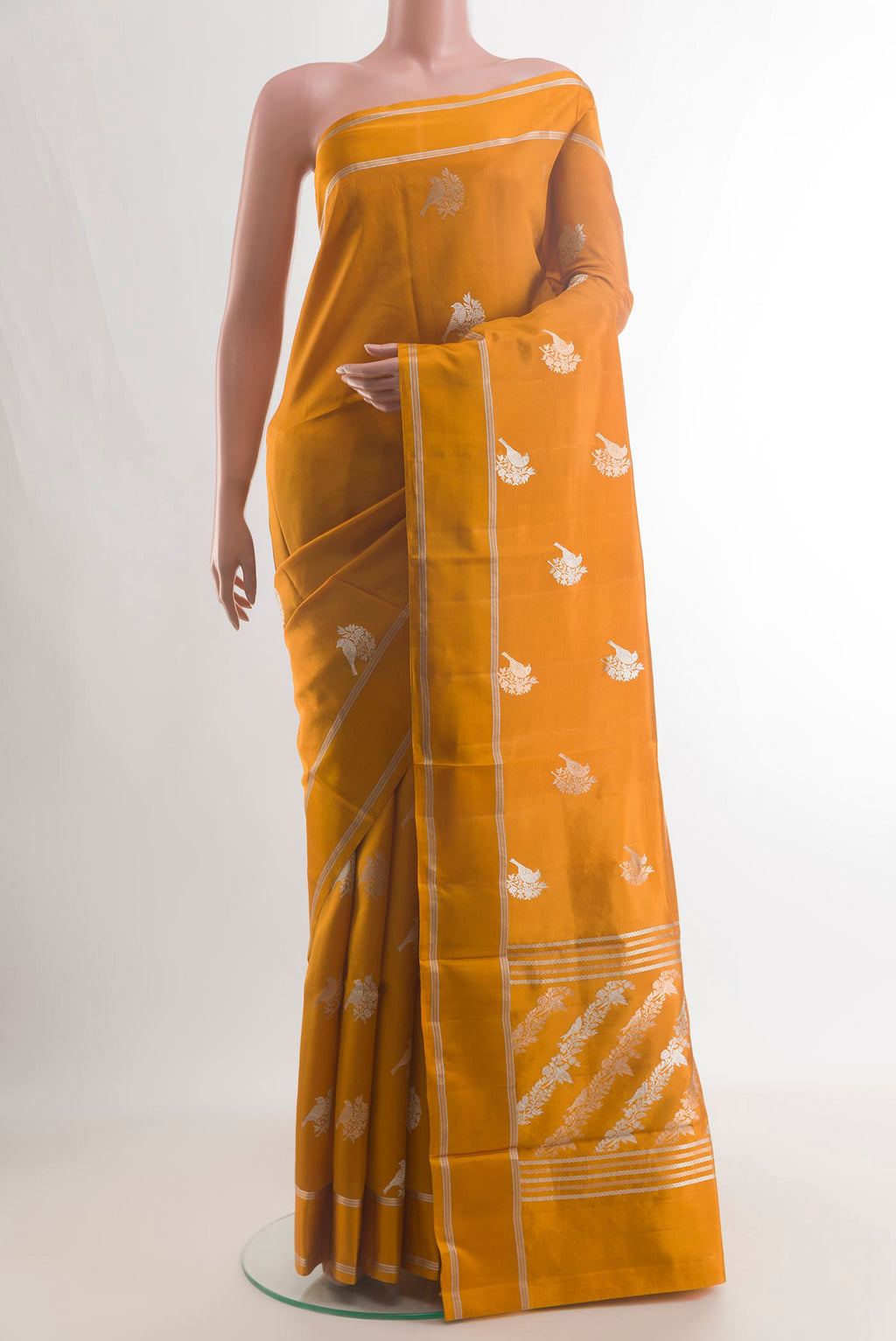 Pure Silk Mustard Banarasi Saree with Zari Butta on the body and Zari Border.  displayed on a mannequin