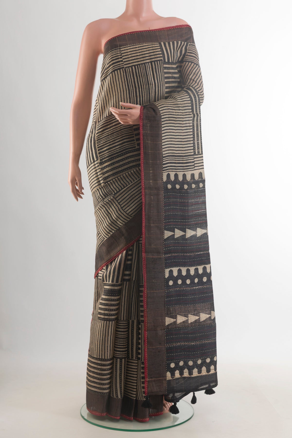 Beige Tussar Saree with Geometric Print on the body and Zari Border.  displayed on a mannequin