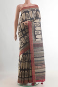 Green Tussar Saree with Printed design on the body and Zari Border.  displayed on a mannequin