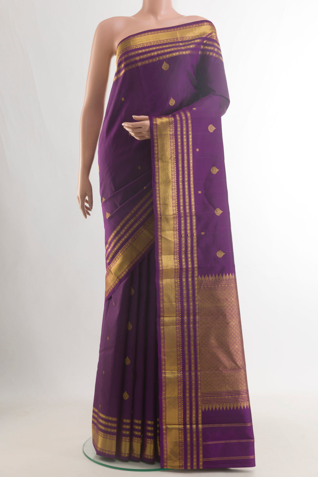 Pure Silk Purple Kanchipuram Saree with Zari Butta on the body and Zari Border.  displayed on a mannequin