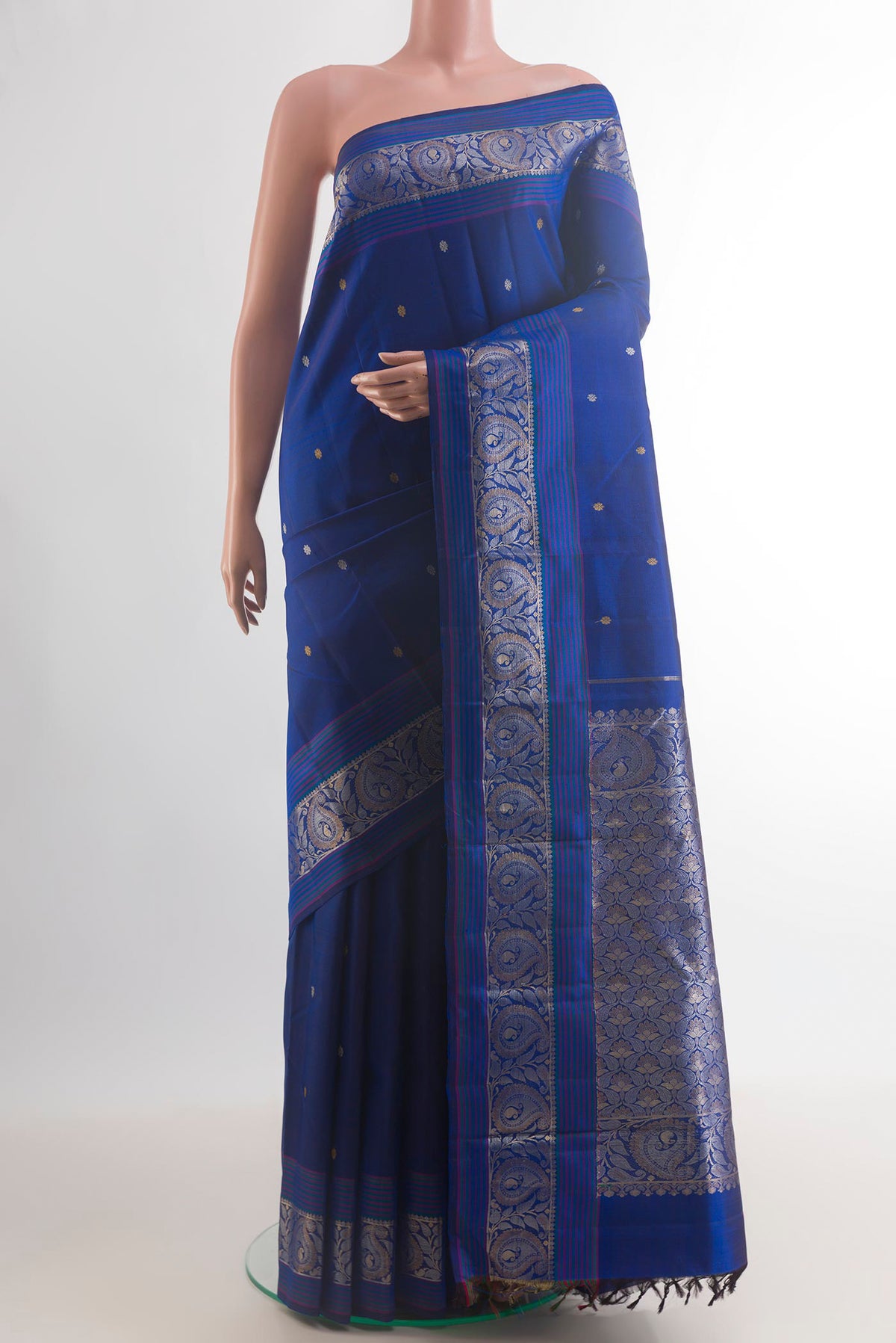 Pure Silk Blue Kanjivaram Saree with Zari Butta on the body and Zari Border.  displayed on a mannequin