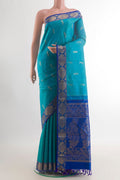 Pure Silk Turquoise Kanjivaram Saree with Zari Butta on the body and Zari Border.  displayed on a mannequin