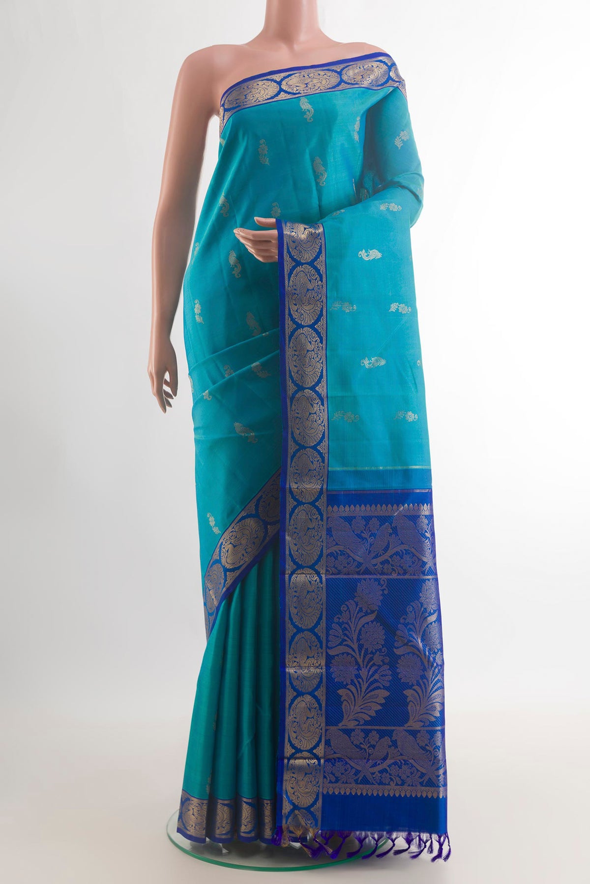 Pure Silk Turquoise Kanjivaram Saree with Zari Butta on the body and Zari Border.  displayed on a mannequin