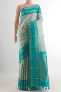 Pure Silk Light Green Kanjivaram Saree with Thread Butta on the body and Zari Border.  displayed on a mannequin