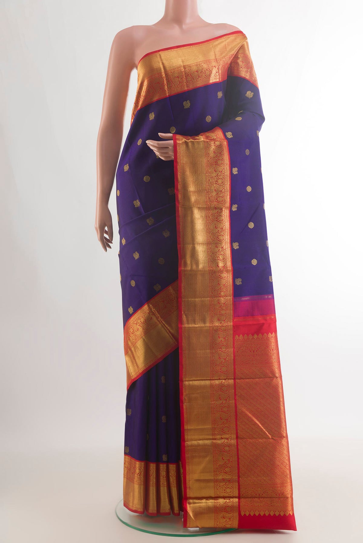 Pure Silk Navy Blue Kanchipuram Saree with Zari Butta on the body and Zari Border.  displayed on a mannequin