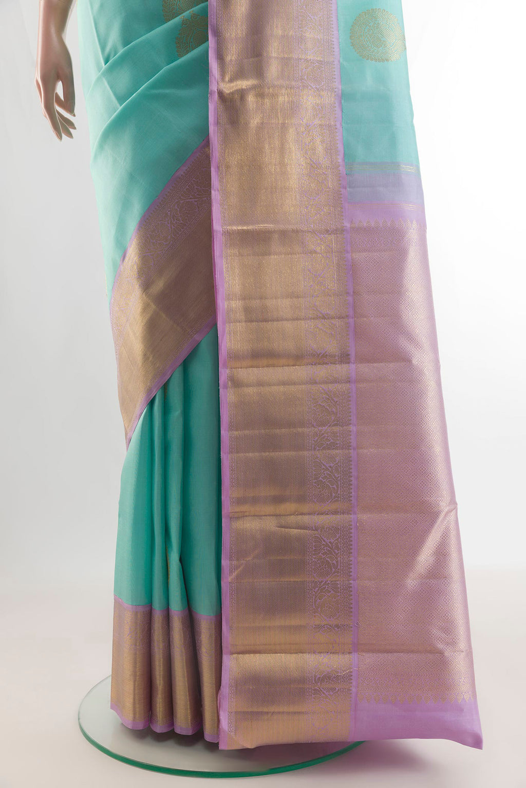 Pleats and pallu of Pure Silk Sea Green Kanchipuram Saree with Zari Butta on the body and Zari Border. 