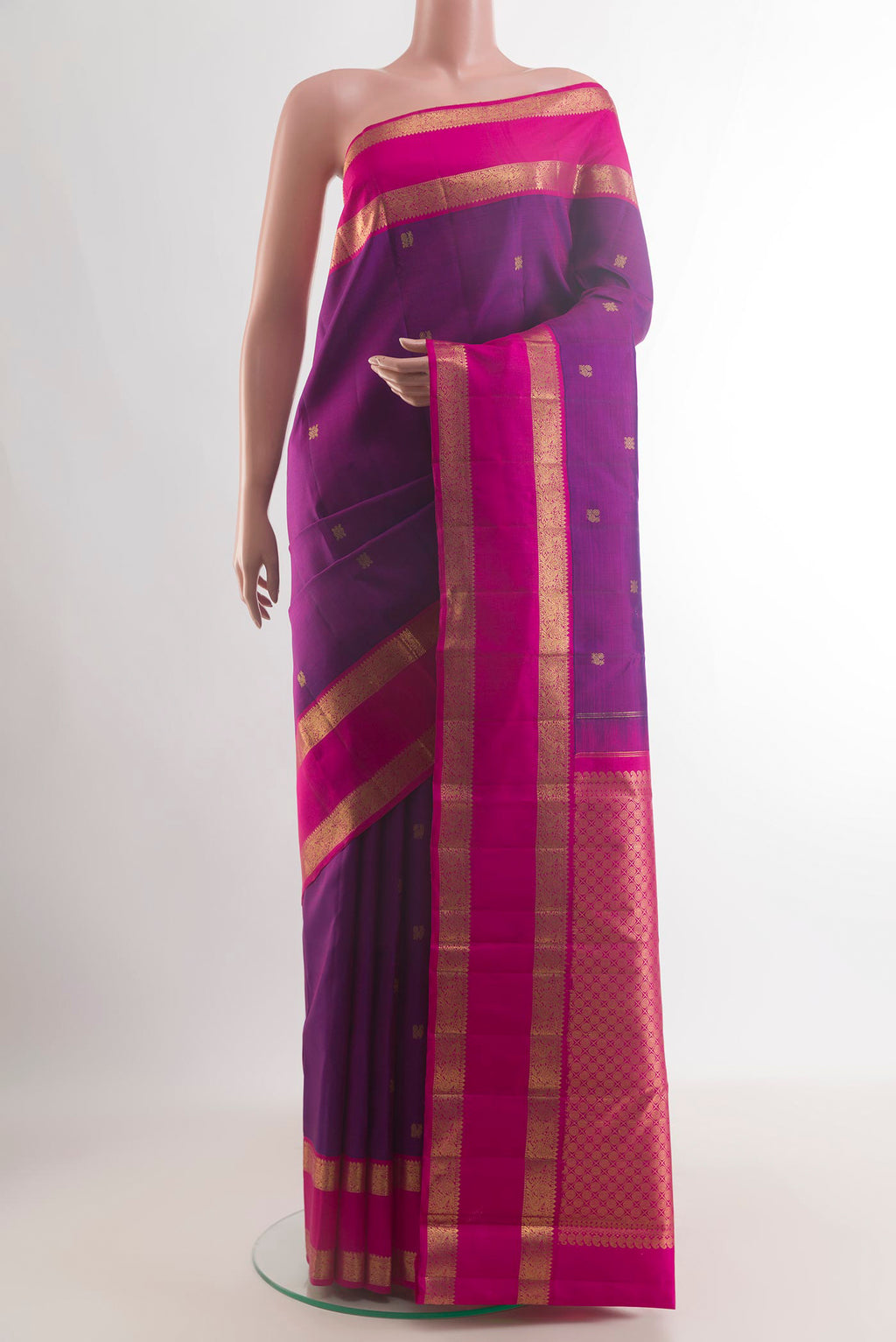 Pure Silk Purple Kanjivaram Saree with Zari Butta on the body and Zari Border.  displayed on a mannequin