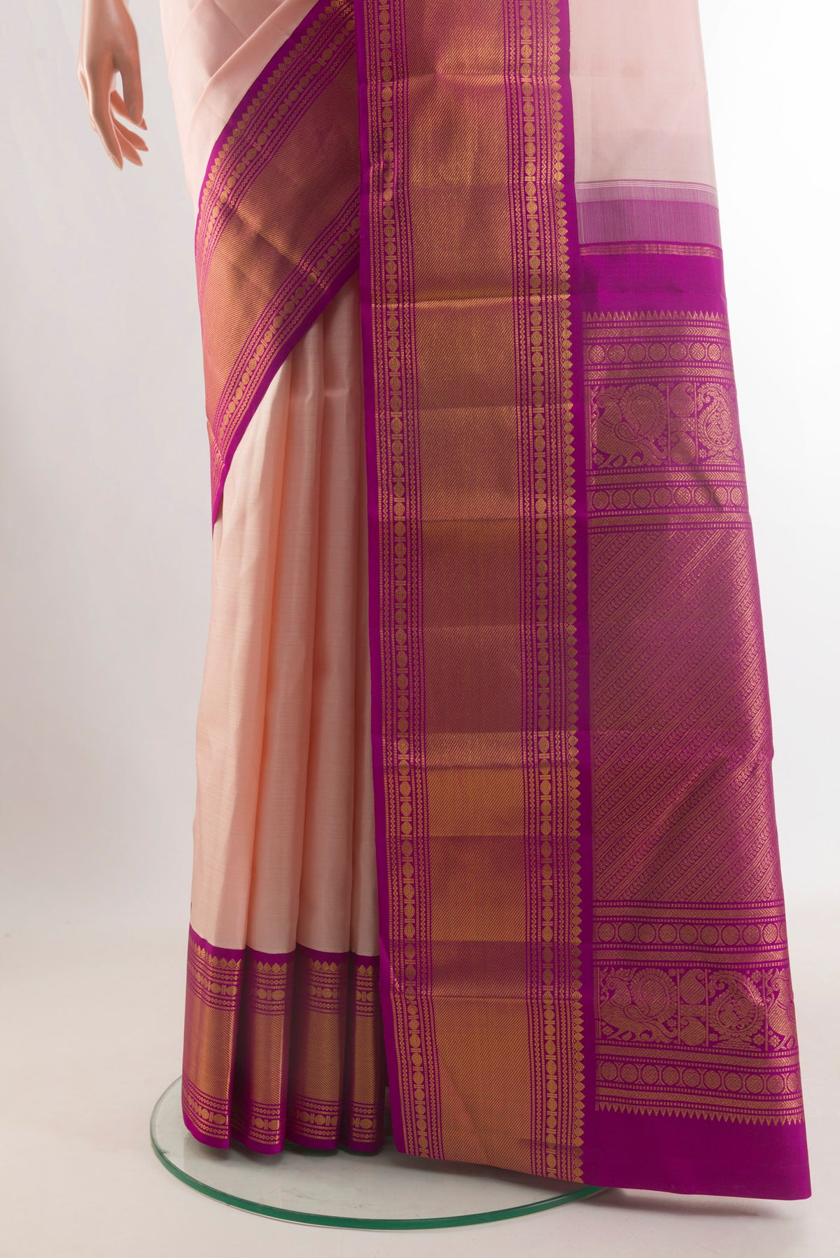 Pleats and pallu of Pure Silk Peach Kanjivaram Saree with Plain Body and Zari Border. 
