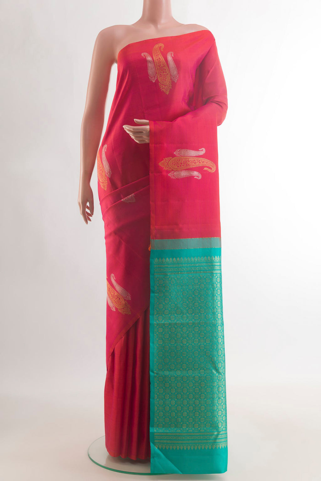 Pure Silk Brick Orange Kanjivaram Saree with Zari Butta on the body and Without Border.  displayed on a mannequin