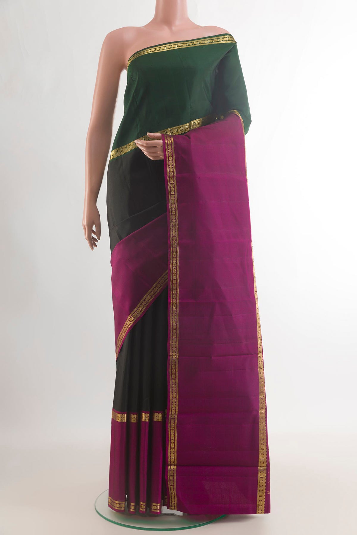 Pure Silk Black Kanchipuram Saree with Plain Body and Ganga Jamuna Border.  displayed on a mannequin