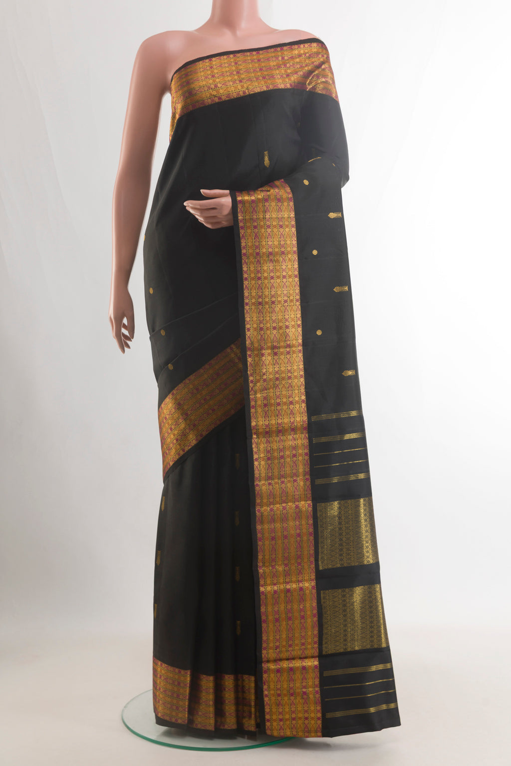 Pure Silk Black Kanjivaram Saree with Zari Butta on the body and Zari Border.  displayed on a mannequin