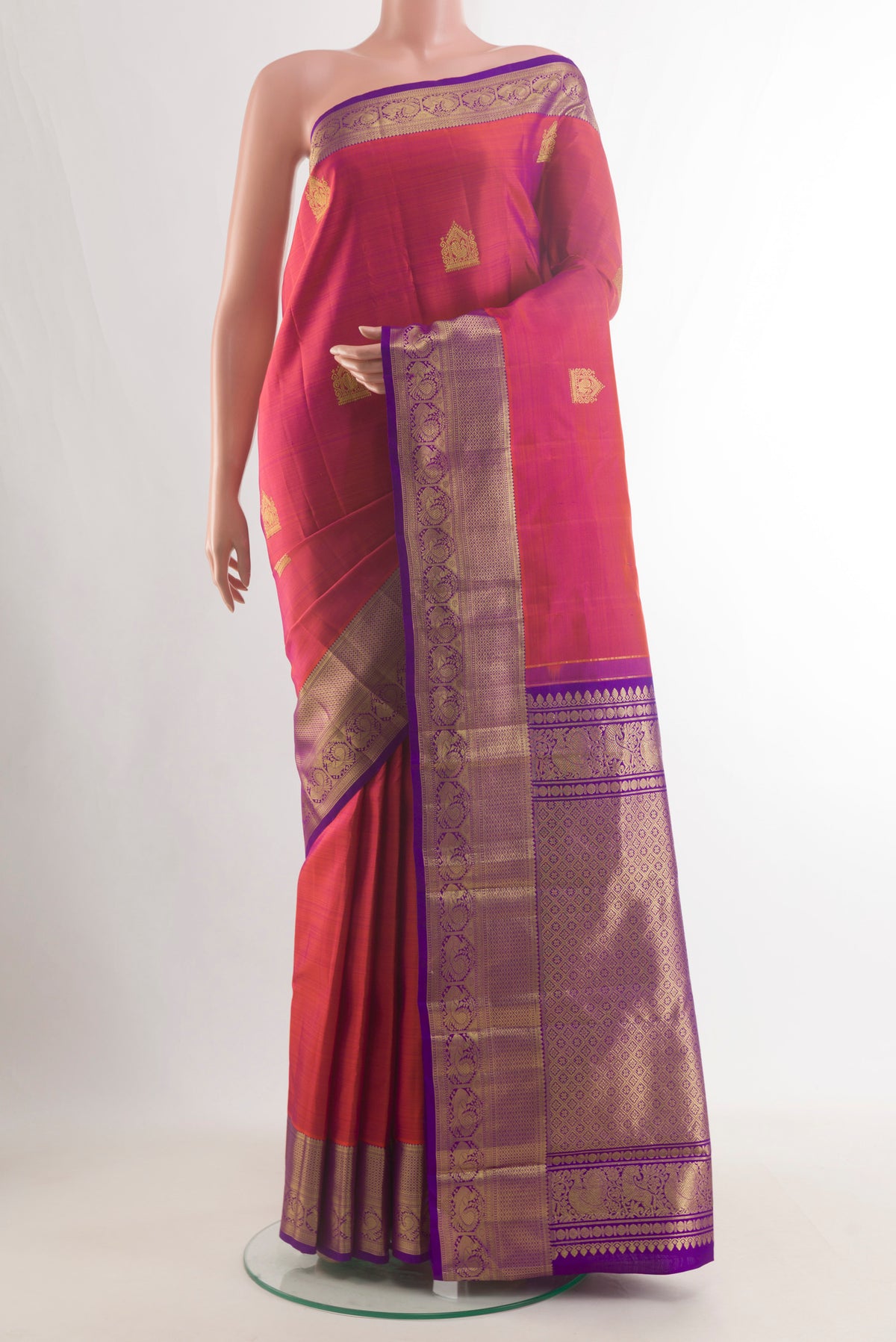 Pure Silk Brick Orange Dual Tone Kanjivaram Saree with Zari Butta on the body and Zari Border.  displayed on a mannequin