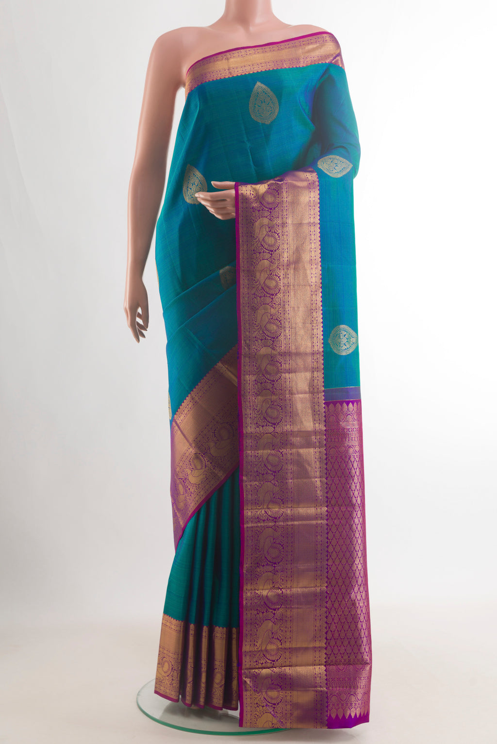 Pure Silk Peacock Blue Kanjivaram Saree with Zari Butta on the body and Zari Border.  displayed on a mannequin