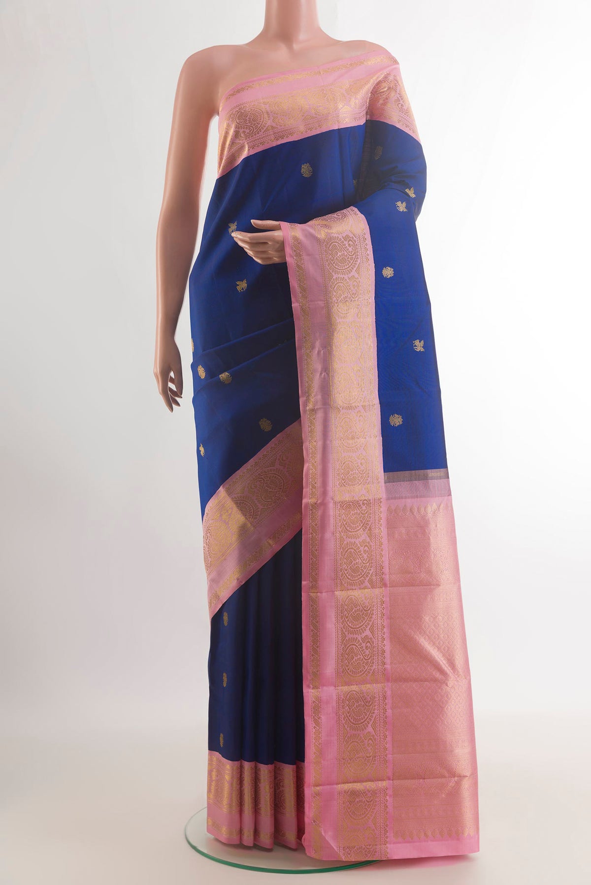 Pure Silk Blue Kanchipuram Saree with Zari Butta on the body and Zari Border.  displayed on a mannequin