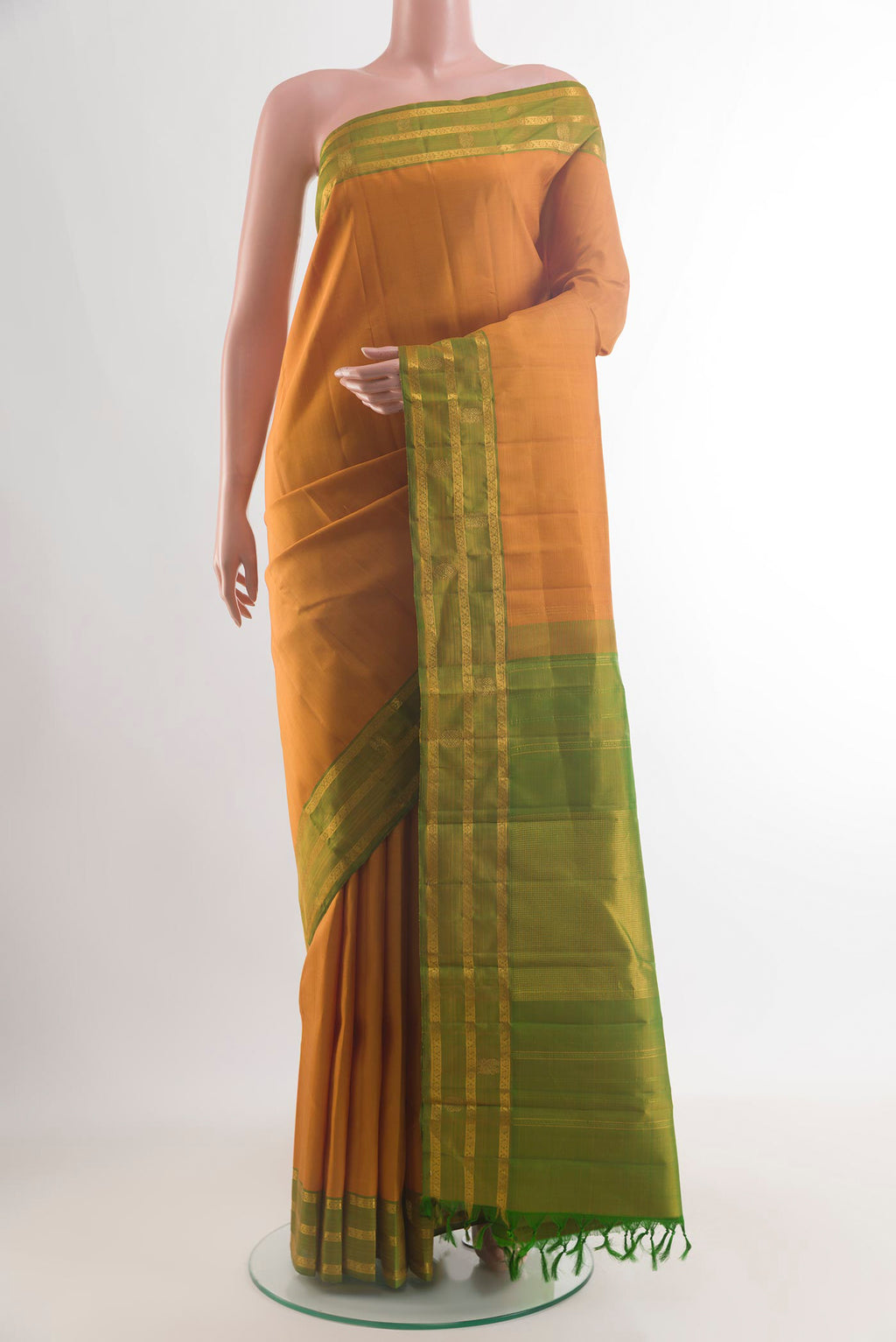 Pure Silk Mustard Kanchipuram Saree with Plain Body and Zari Border.  displayed on a mannequin