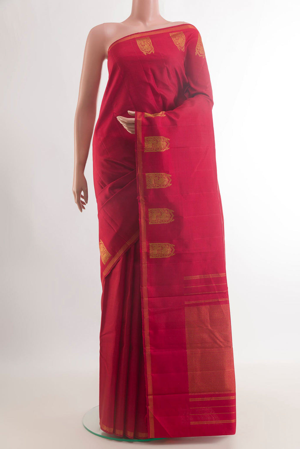 Pure Silk Red Kanchipuram Saree with Plain Body and Zari Border.  displayed on a mannequin