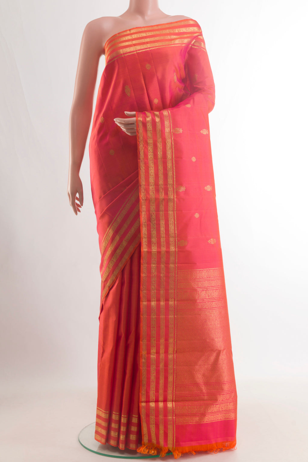 Pure Silk Orange Kanchipuram Saree with Zari Butta on the body and Zari Border.  displayed on a mannequin