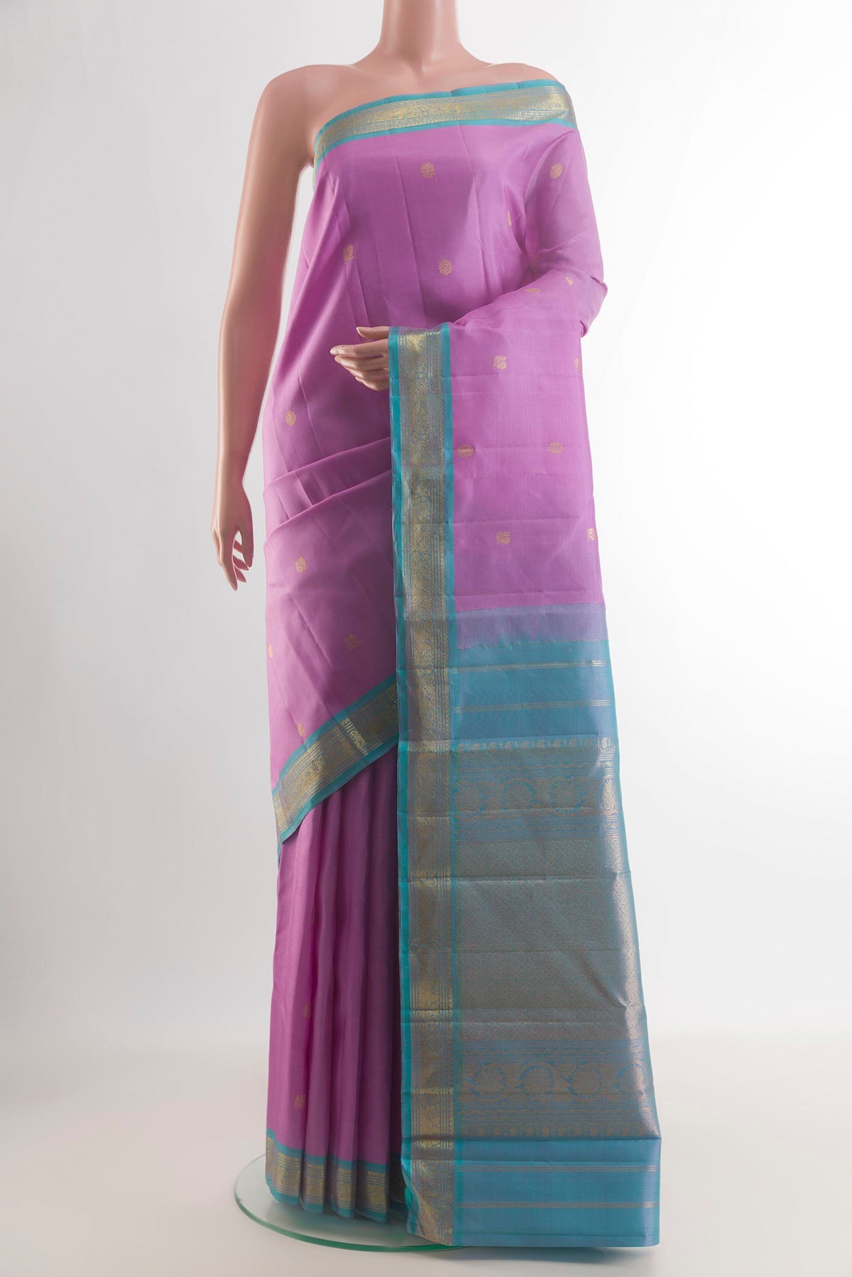 Pure Silk Lavender Kanchipuram Saree with Zari Butta on the body and Zari Border.  displayed on a mannequin