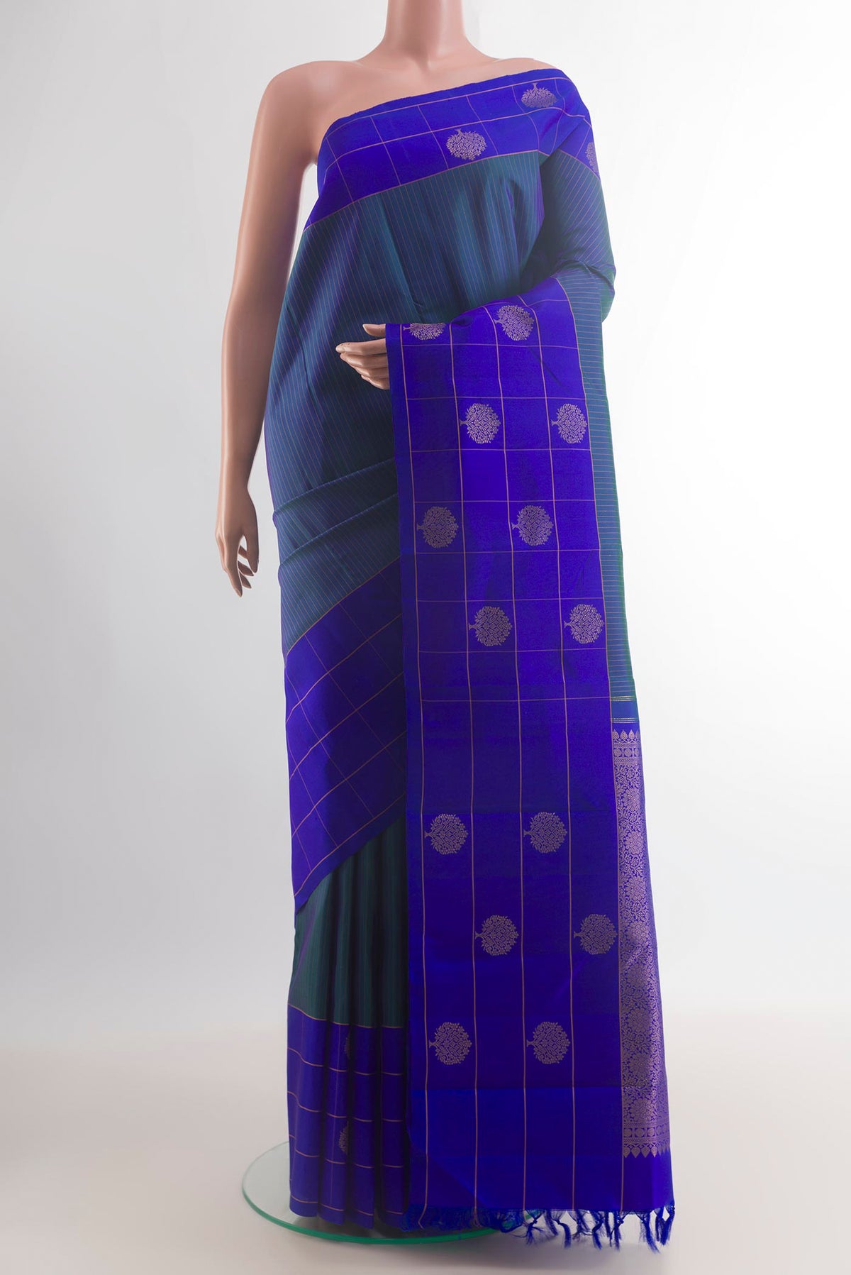 Pure Silk Peacock Blue Kanchipuram Saree with Stripes on the body and Zari Border.  displayed on a mannequin