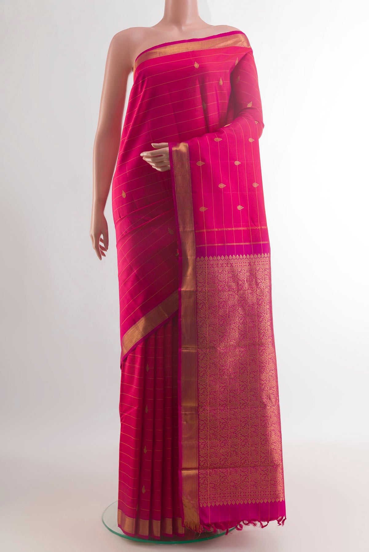 Pure Silk Pink Kanchipuram Saree with Stripes on the body and Zari Border.  displayed on a mannequin