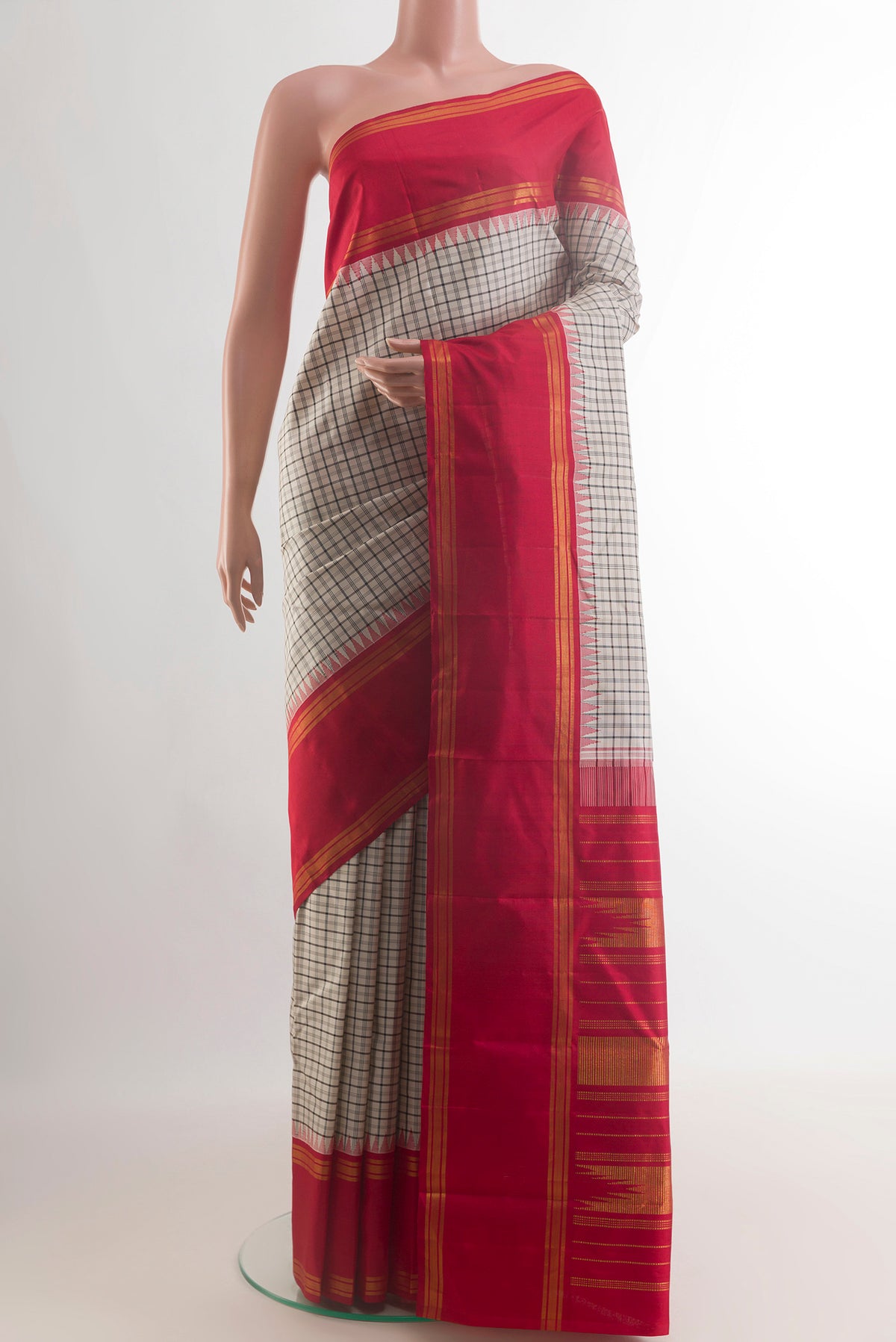 Pure Silk Off White Kanjivaram Saree with Checked design on the body and Zari Border.  displayed on a mannequin