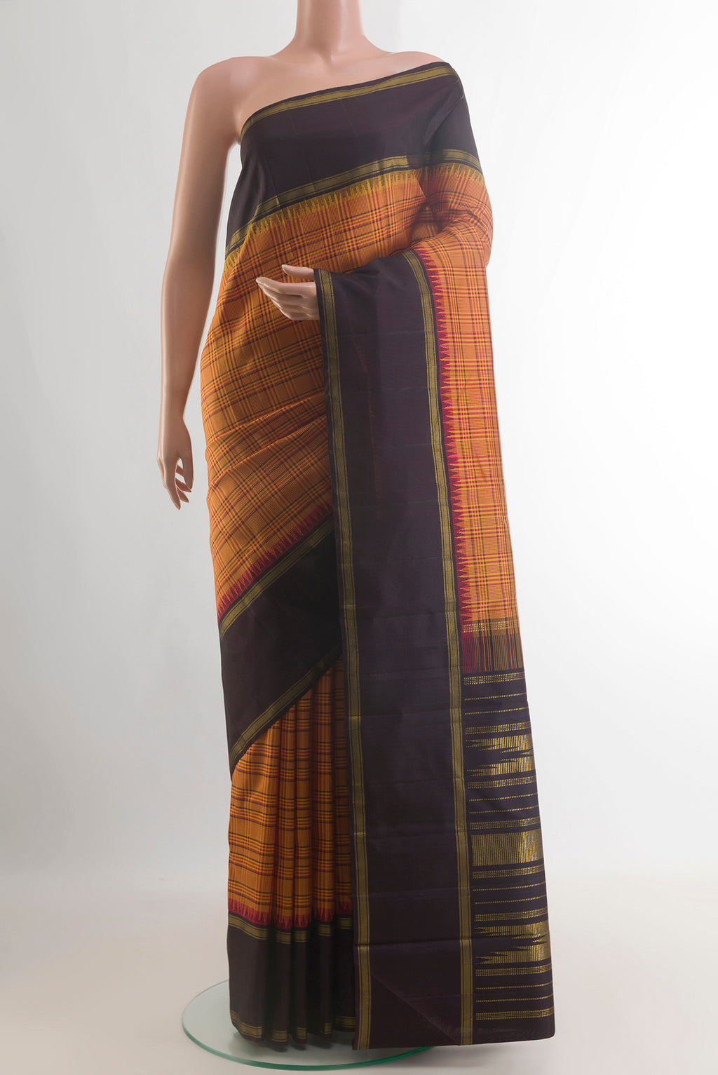 Pure Silk Mustard Kanjivaram Saree with Checked design on the body and Zari Border.  displayed on a mannequin