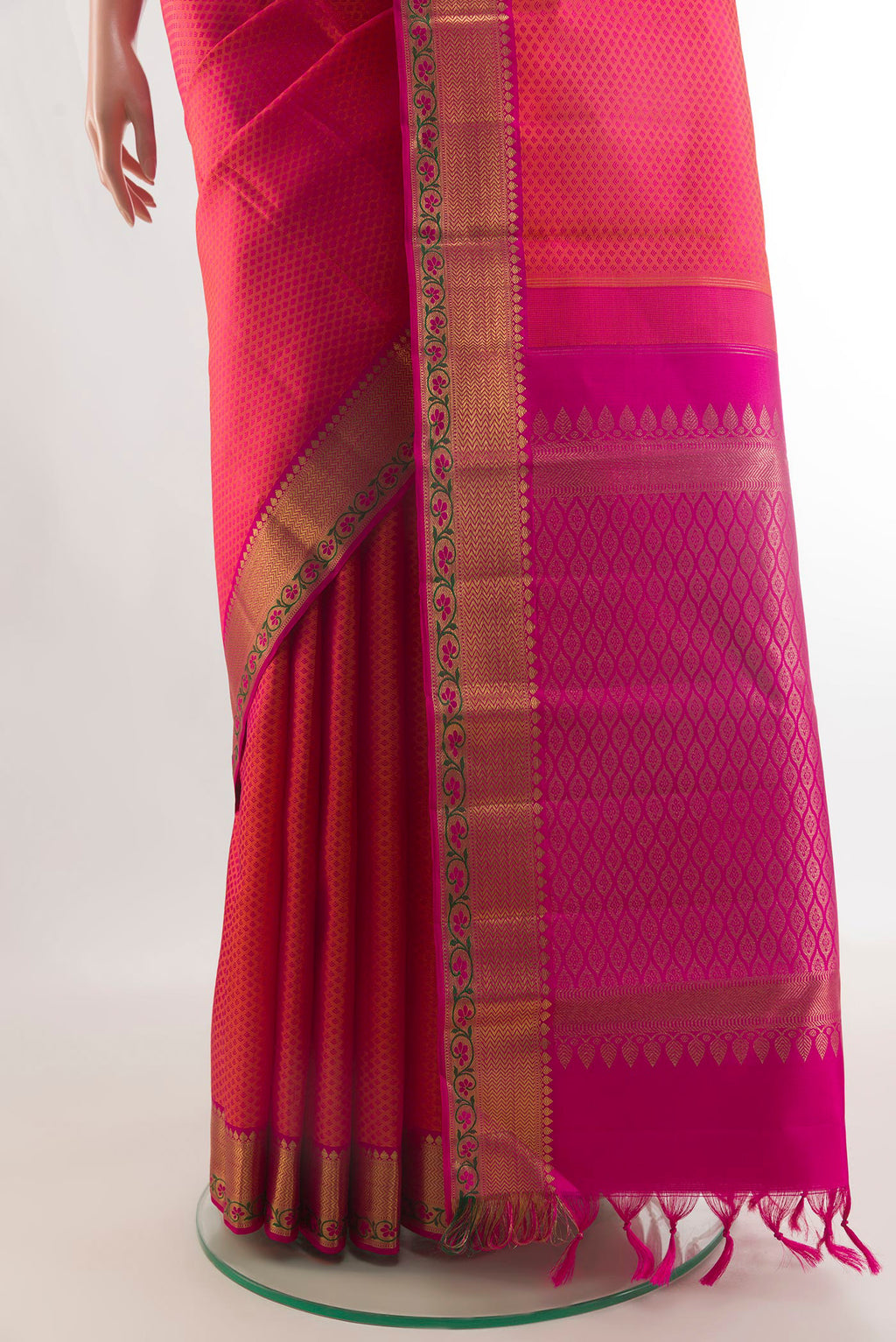 Pleats and pallu of Pure Silk Orange with Pink Color Kanchipuram Saree with Jacquard design on the body and Zari Border. 