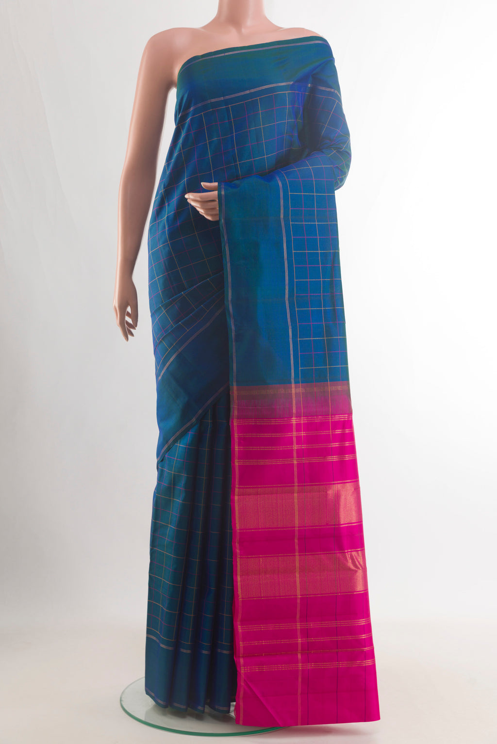 Pure Silk Peacock Blue Kanjivaram Saree with Checked design on the body and Zari Border.  displayed on a mannequin