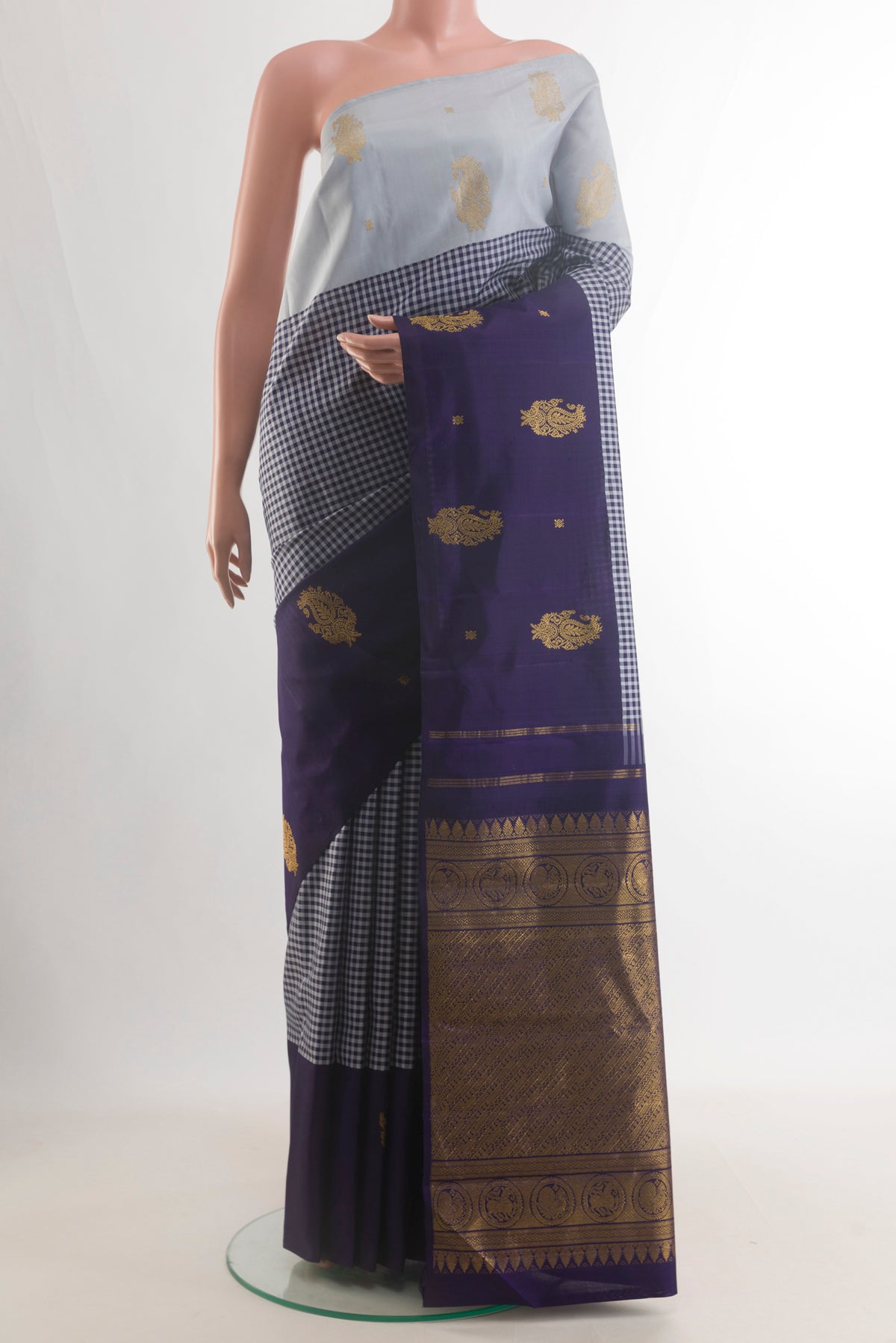 Pure Silk Navy Blue Kanjivaram Saree with Checked design on the body and Ganga Jamuna Border.  displayed on a mannequin