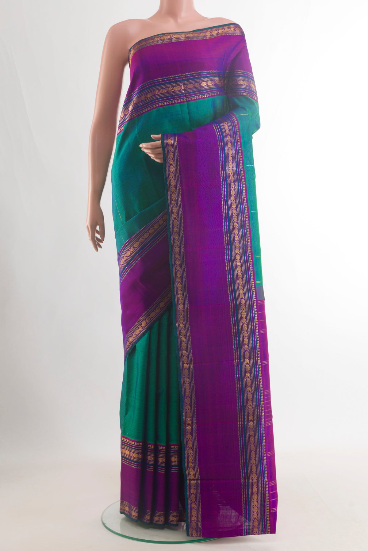 Pure Silk Green Kanjivaram Saree with Zari Butta on the body and Zari Border.  displayed on a mannequin