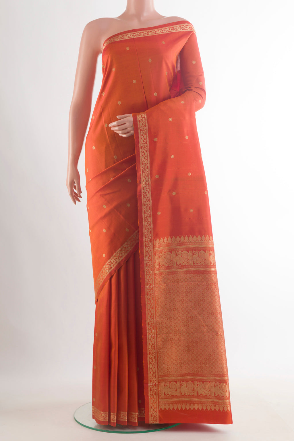 Pure Silk Orange Kanjivaram Saree with Thread Butta on the body and Thread Border.  displayed on a mannequin