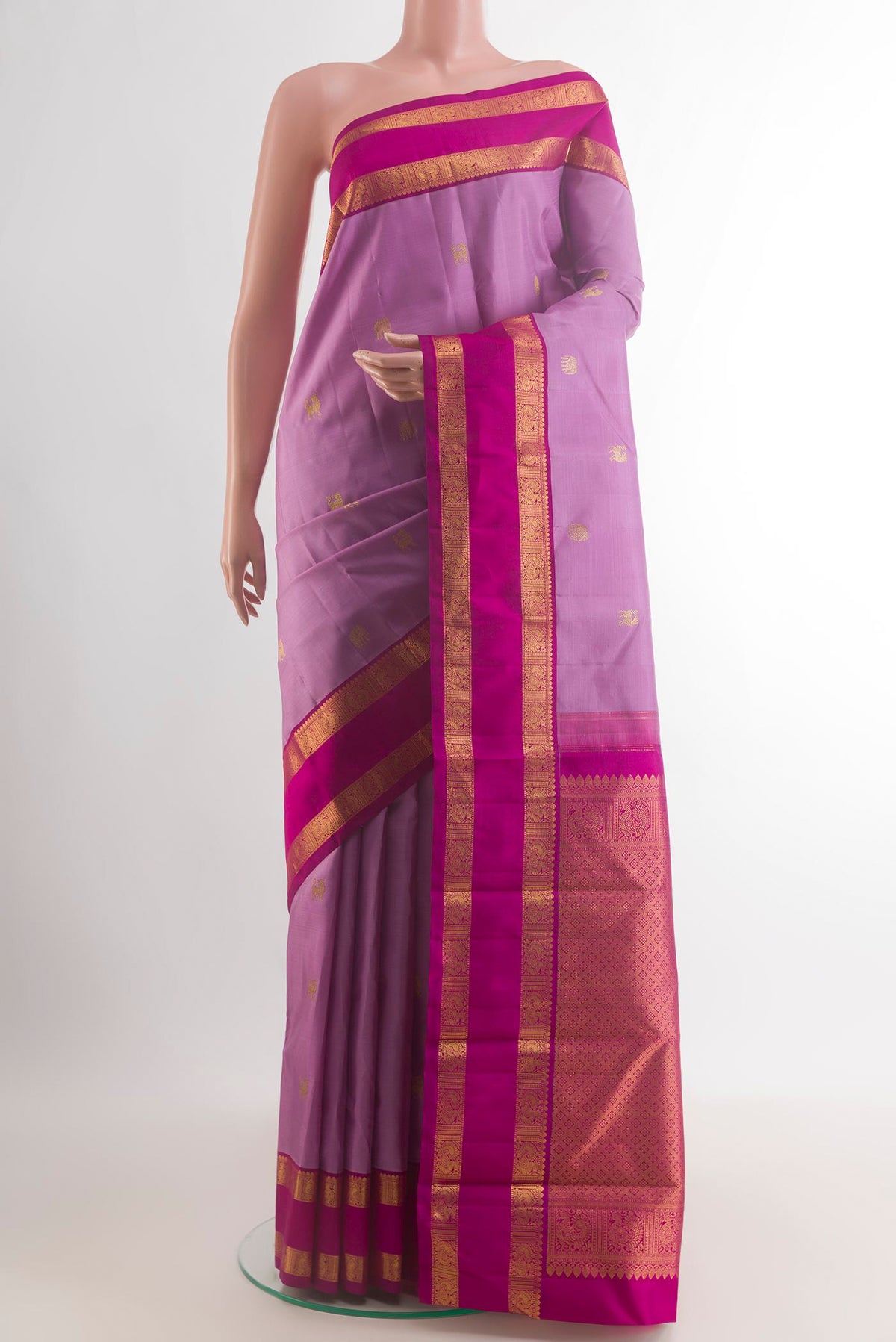 Pure Silk Lavender Kanjivaram Saree with Zari Butta on the body and Zari Border.  displayed on a mannequin