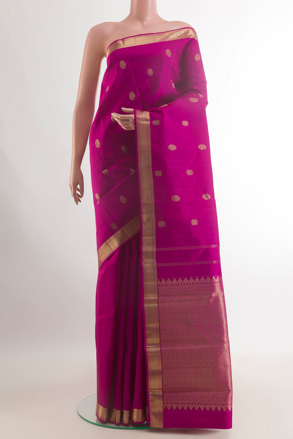 Pure Silk Magenta Kanchipuram Saree with Zari Butta on the body and Zari Border.  displayed on a mannequin