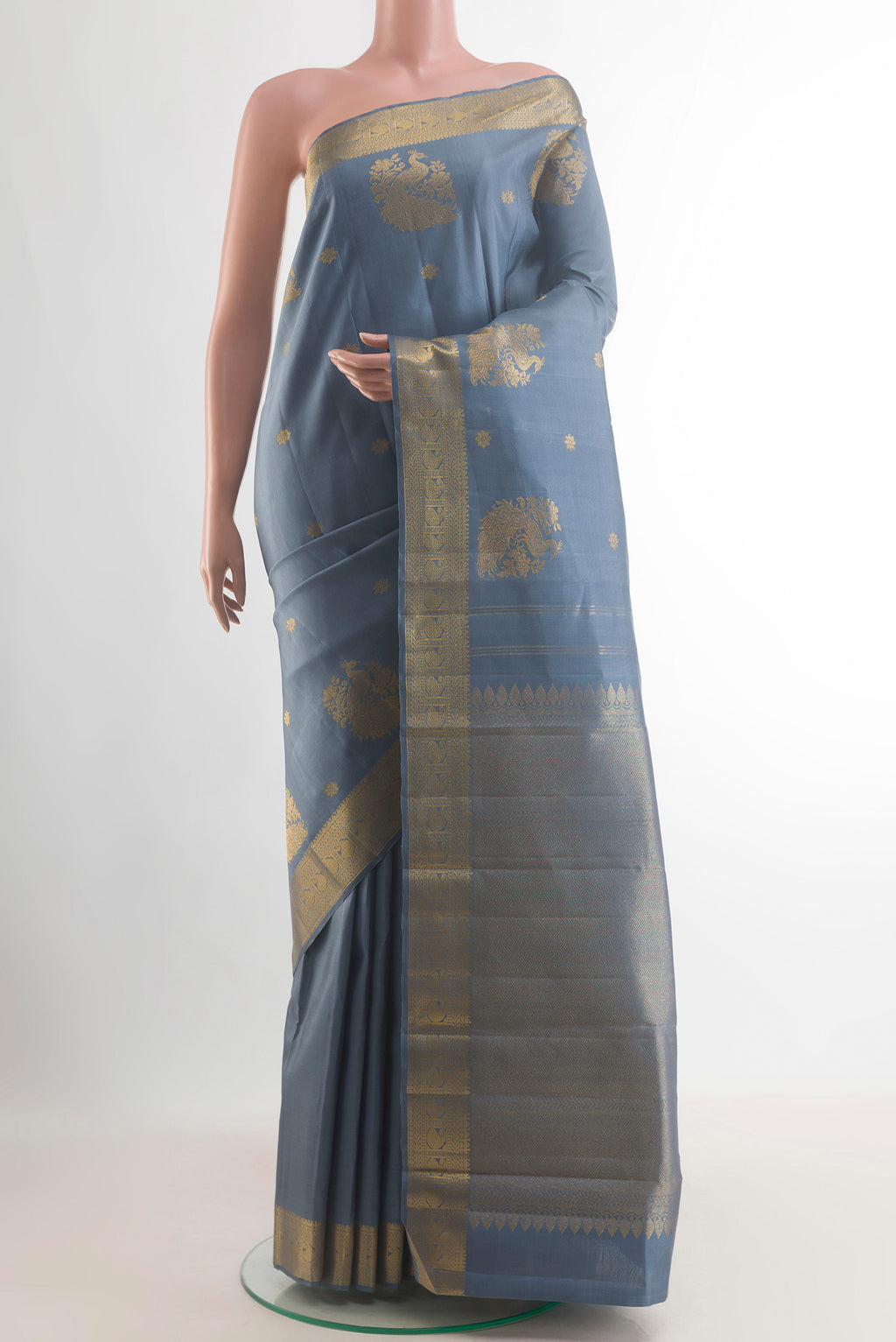 Pure Silk Blue Grey Kanchipuram Saree with Zari Butta on the body and Zari Border.  displayed on a mannequin