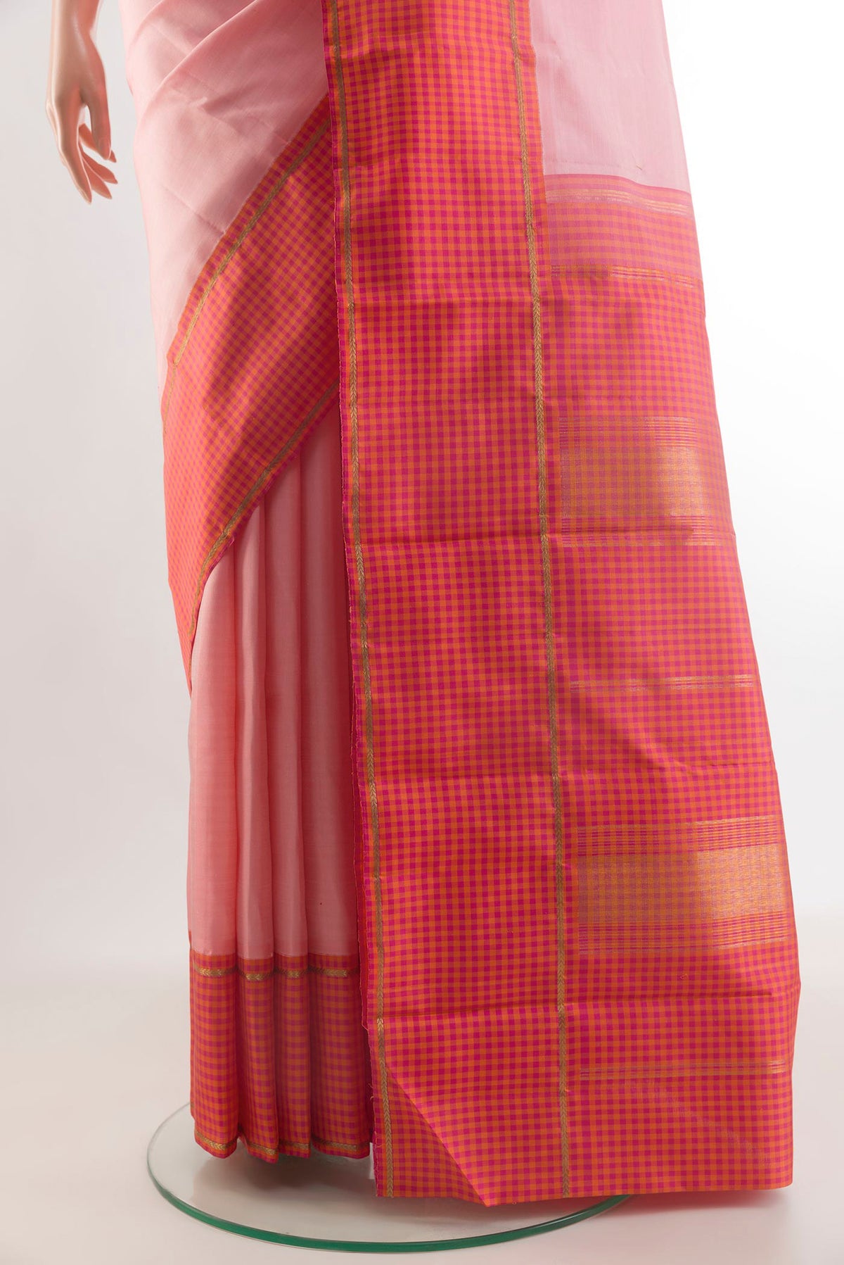 Pleats and pallu of Pure Silk Peach Kanjivaram Saree with Plain Body and Checks Border. 