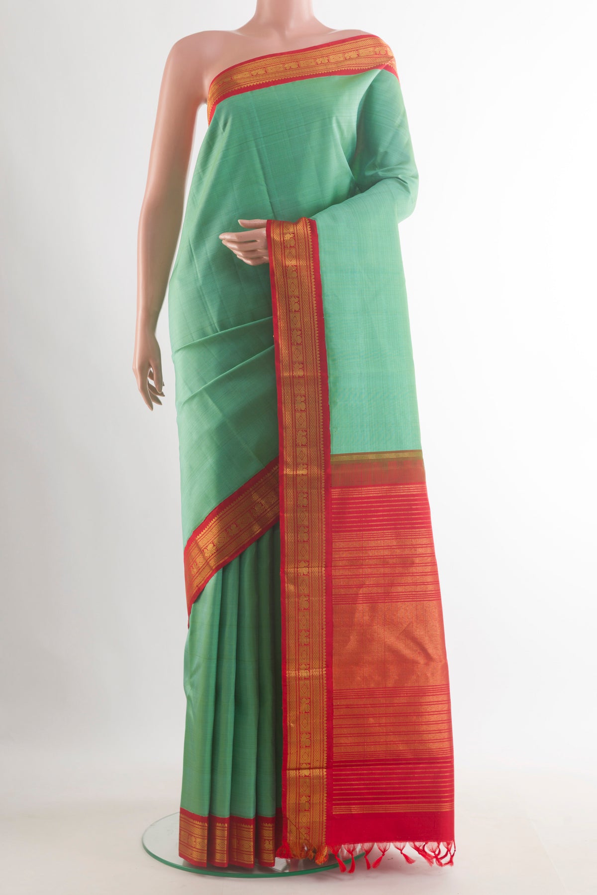 Pure Silk Sea Green Kanjivaram Saree with Plain Body and Zari Border.  displayed on a mannequin