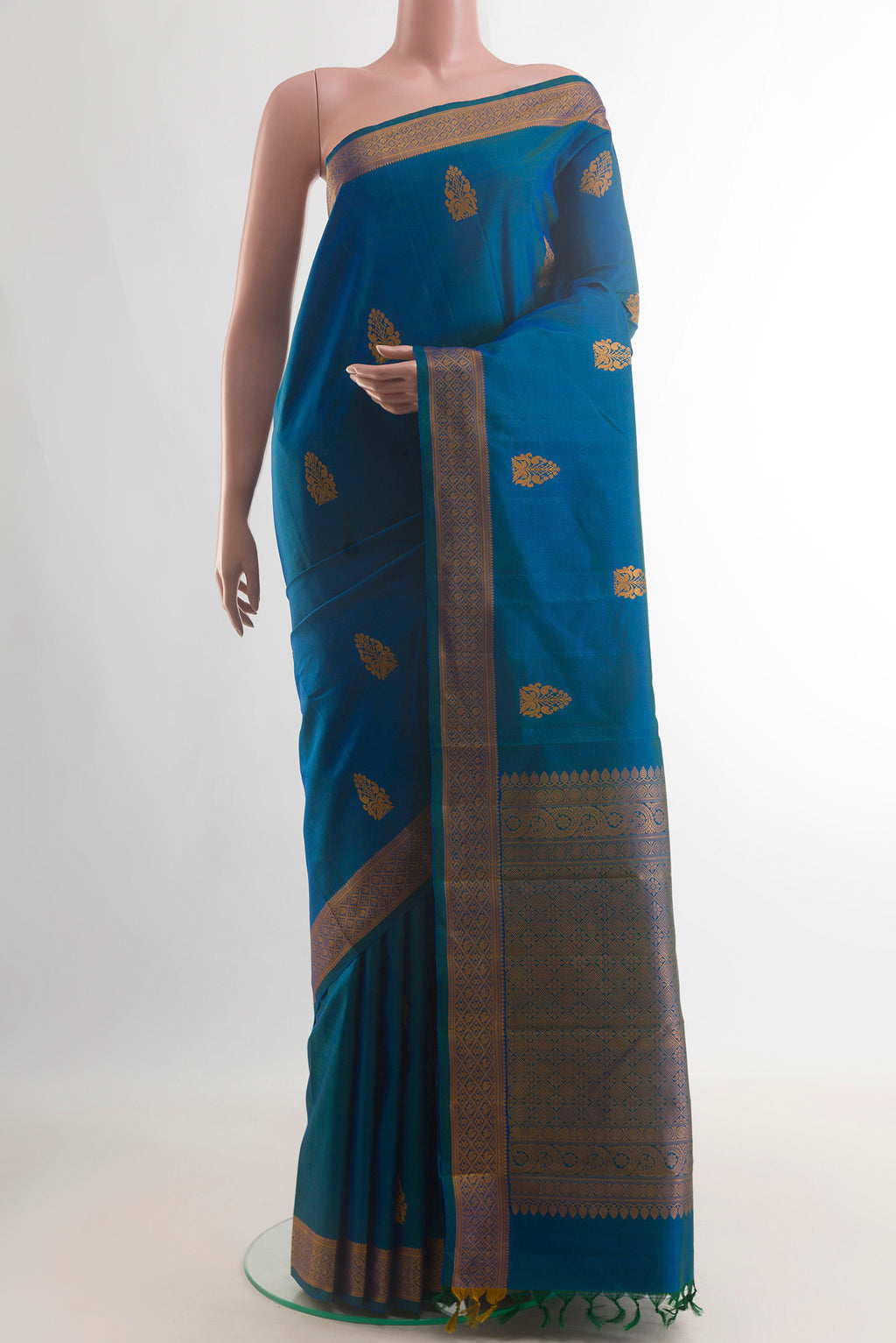 Pure Silk Blue Kanjivaram Saree with Thread Butta on the body and Thread Border.  displayed on a mannequin